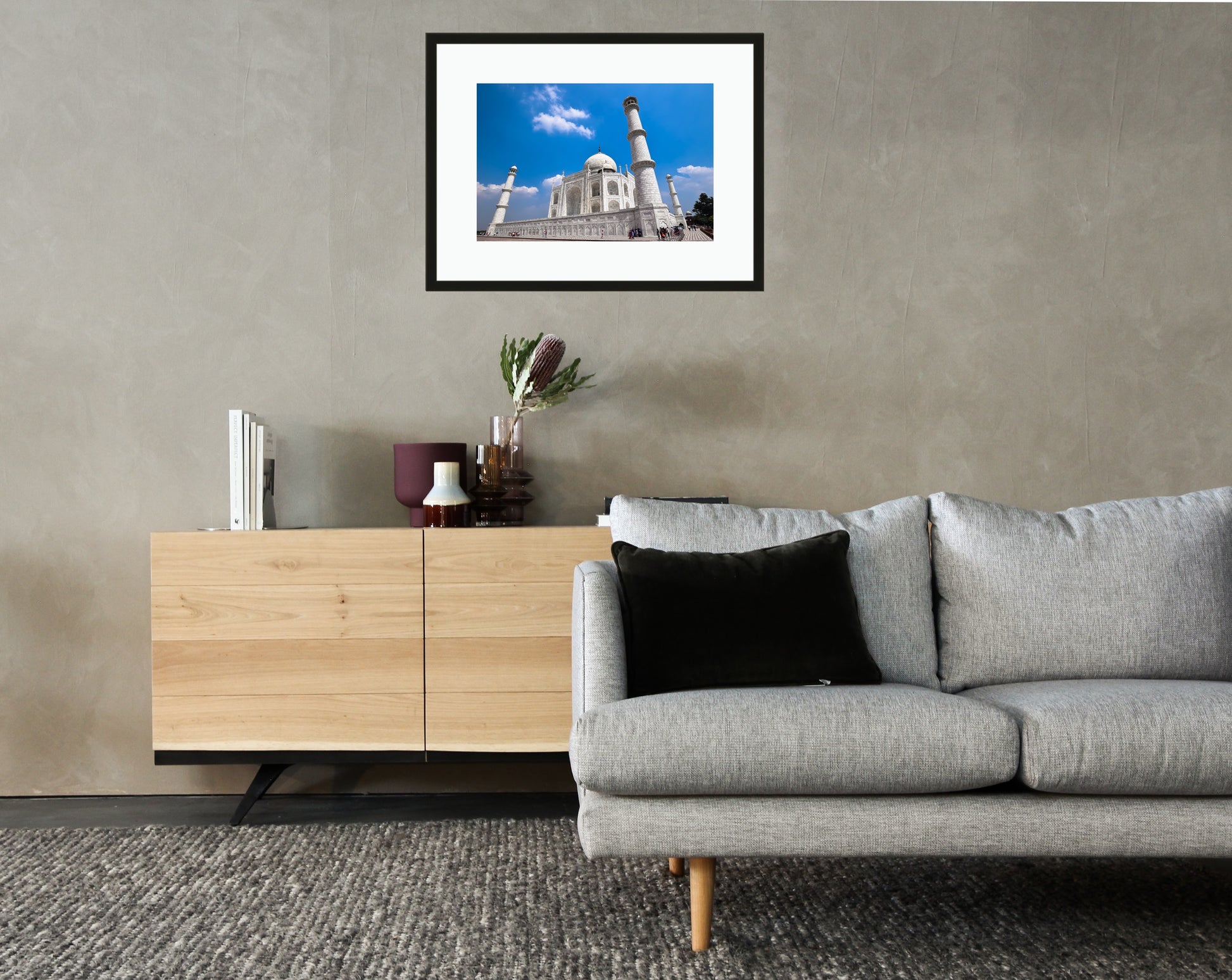 Framed and mounted photograph of the Taj Mahal in Agra hanging on a wall above a sofa and cupboard